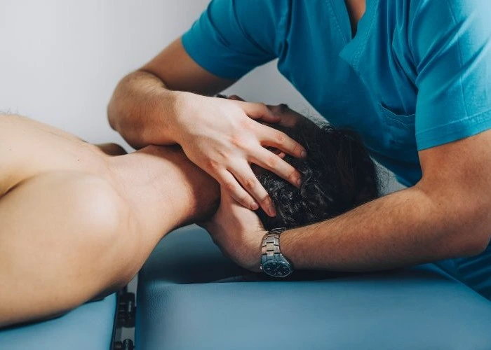 Chiropractor performing neck adjustment.