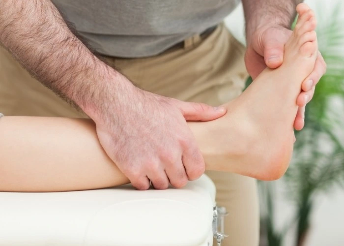 Therapist examining foot and ankle for numbness or pain