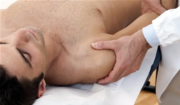 Chiropractor checking the arm of the patient