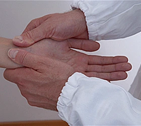 Doctor examining a patient's hand for numbness