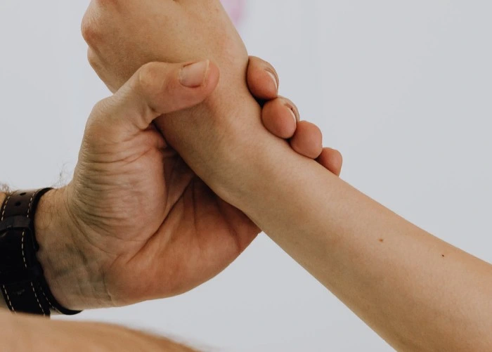 Doctor checking the hands of patient for numbness