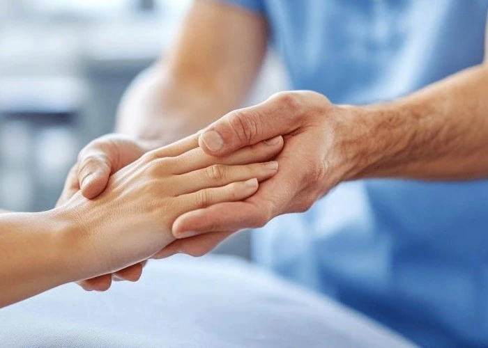 Medical professional examining hand for numbness or nerve issues