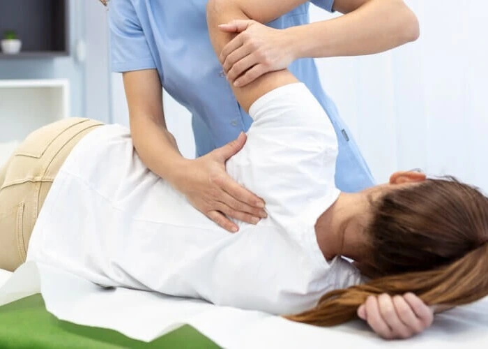 Spinal adjustment by chiropractor.