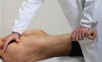 Chiropractor pressing the back of patient and stretching his hand