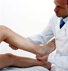 Doctor examining a patient’s leg