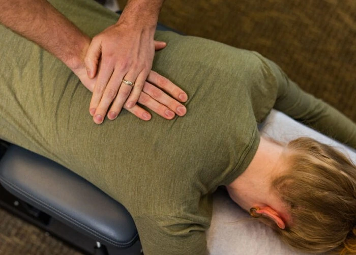 Chiropractor performing back adjustment.