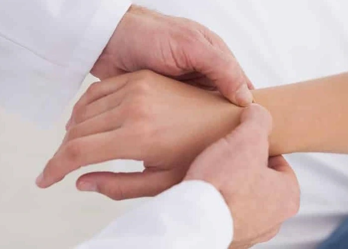 Doctor checking wrist and hand for signs of numbness